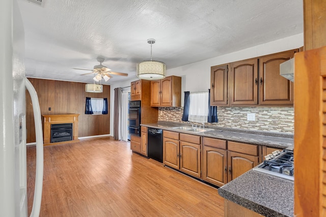 kitchen with black appliances, ceiling fan, pendant lighting, sink, and tasteful backsplash