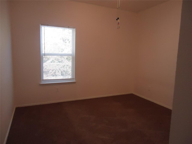 empty room with dark colored carpet