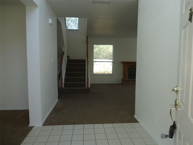 hallway with light colored carpet