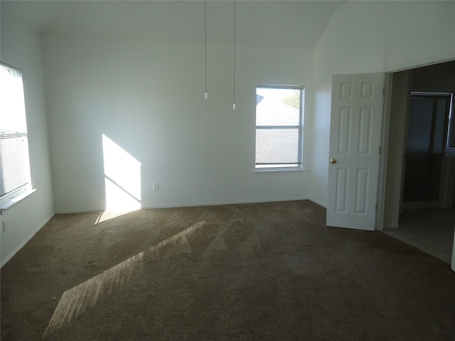 unfurnished room featuring dark colored carpet