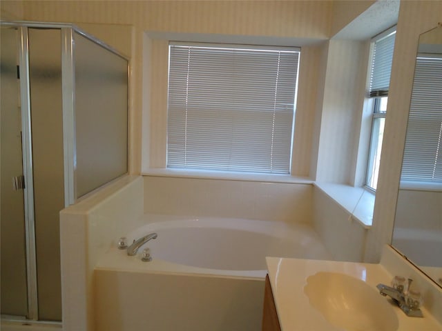 bathroom featuring vanity and shower with separate bathtub