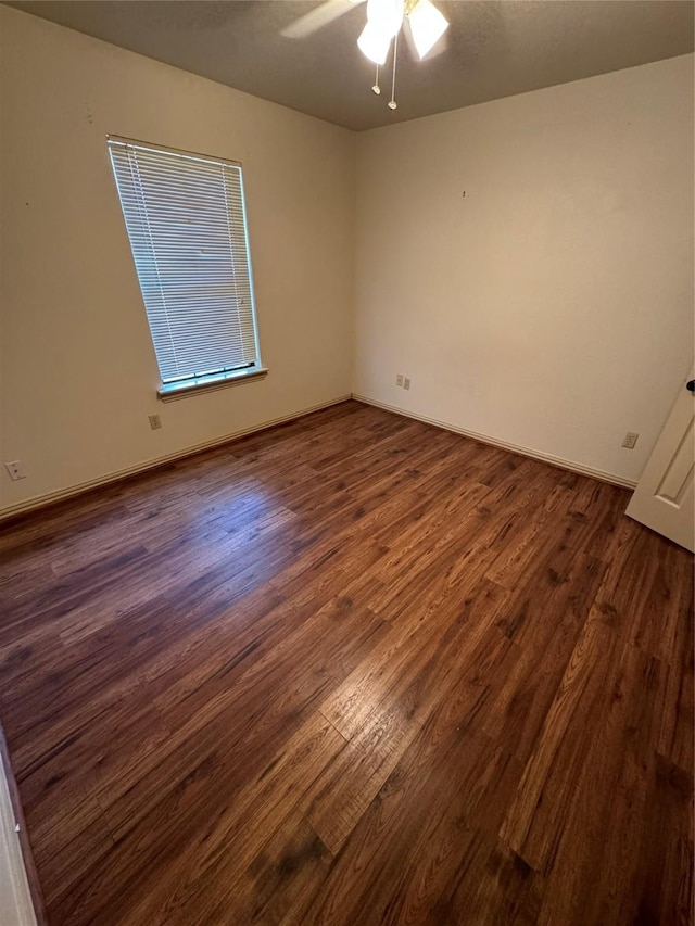 unfurnished room with ceiling fan and dark hardwood / wood-style flooring