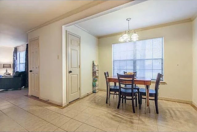 dining space featuring a notable chandelier, light tile patterned flooring, and ornamental molding