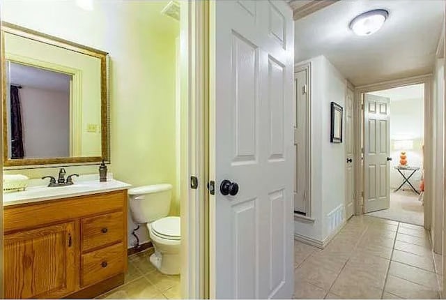 bathroom featuring tile patterned flooring, vanity, and toilet