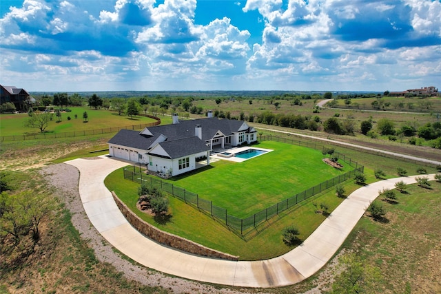 birds eye view of property with a rural view