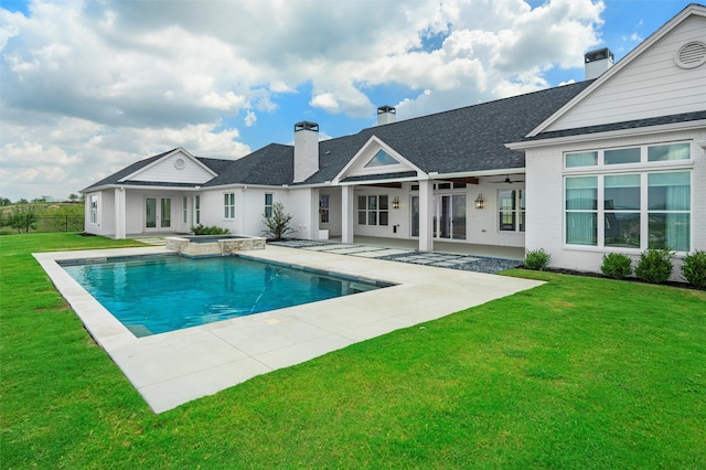 view of swimming pool with a patio area, an in ground hot tub, a yard, and ceiling fan