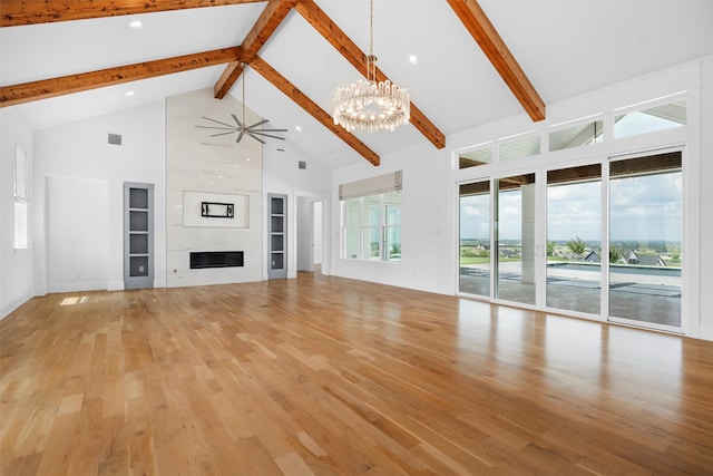 unfurnished living room with beam ceiling, light hardwood / wood-style flooring, and high vaulted ceiling