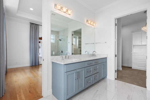 bathroom with hardwood / wood-style floors, vanity, ornamental molding, and a shower with door