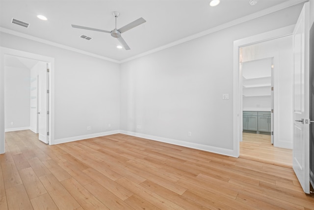 spare room featuring ceiling fan, light hardwood / wood-style floors, and ornamental molding