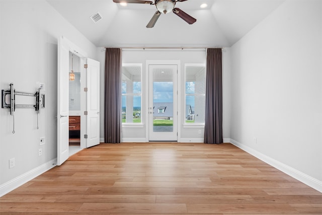 interior space featuring ceiling fan, light wood-type flooring, and lofted ceiling