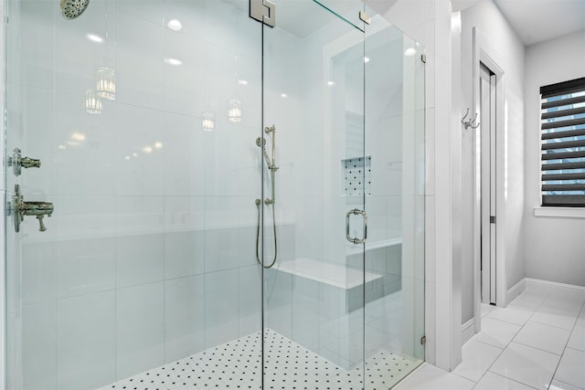 bathroom with tile patterned flooring and a shower with shower door