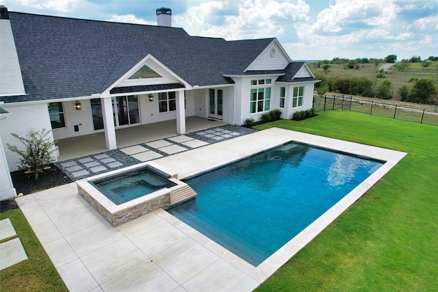 rear view of property featuring a patio area, a yard, and a pool with hot tub