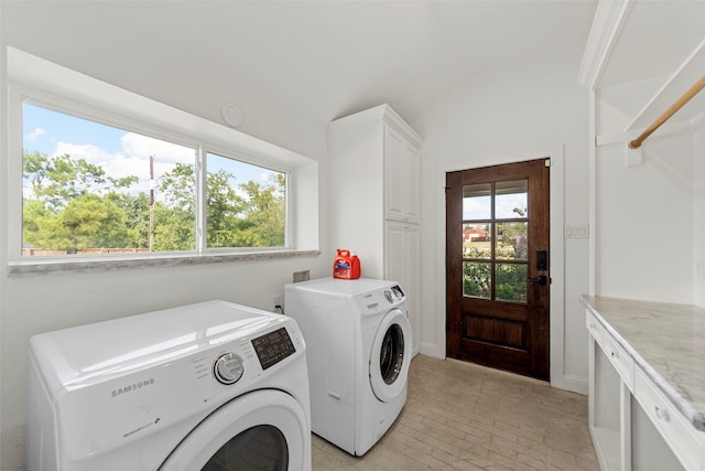 laundry room featuring independent washer and dryer and cabinets