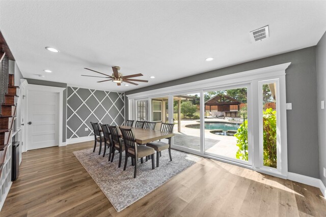 dining space with ceiling fan and dark hardwood / wood-style flooring