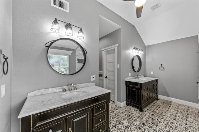 bathroom with ceiling fan, vanity, and vaulted ceiling