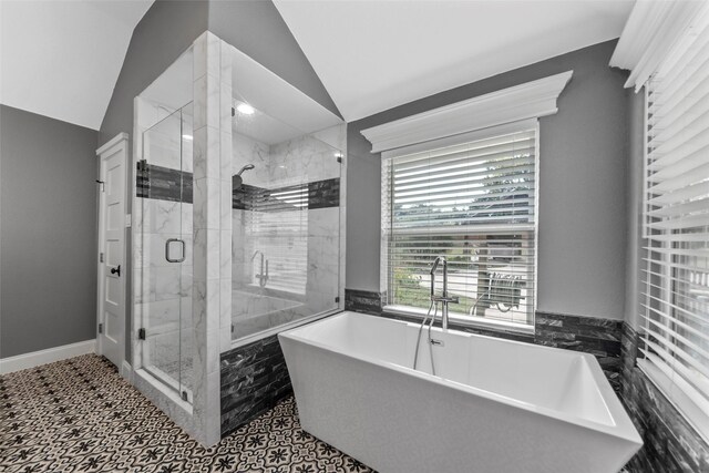 bathroom with independent shower and bath and vaulted ceiling