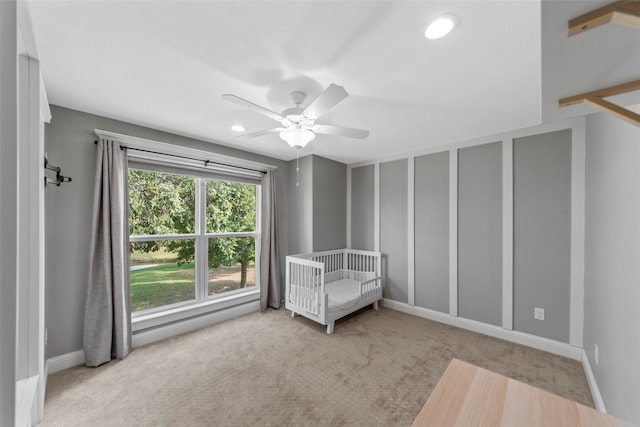 unfurnished bedroom featuring light colored carpet and ceiling fan