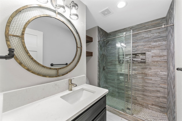 bathroom with vanity and a shower with shower door