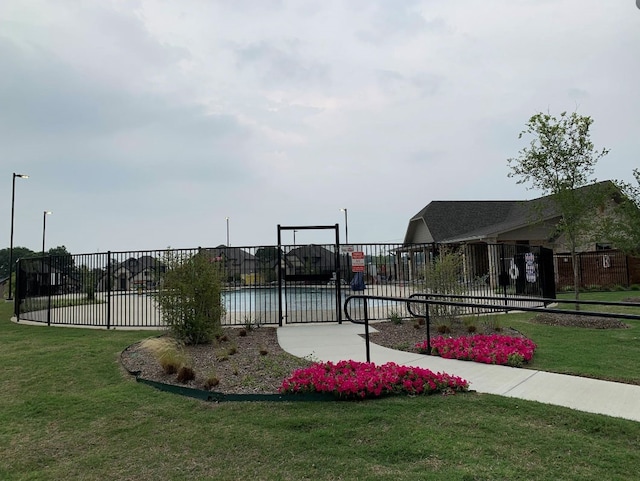 view of property's community with a yard and a swimming pool