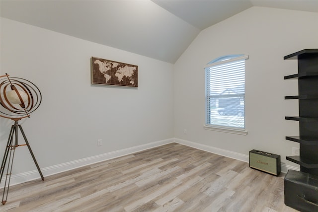 empty room featuring light hardwood / wood-style floors and lofted ceiling