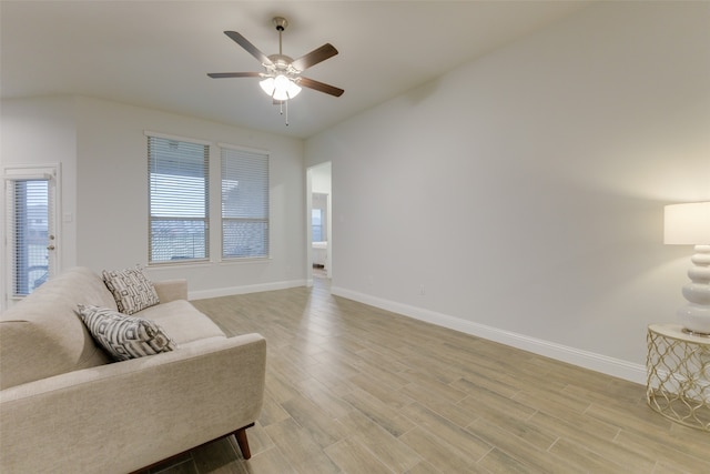 living area with ceiling fan and light hardwood / wood-style flooring