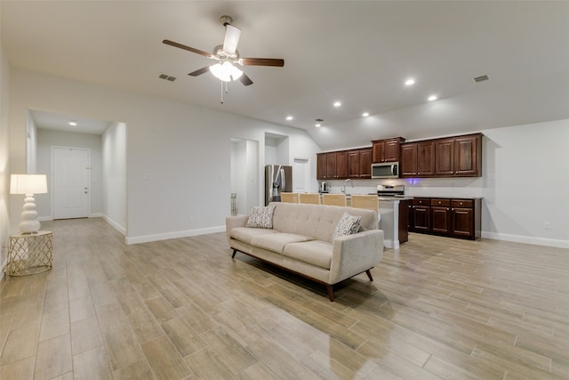 living room featuring light hardwood / wood-style flooring and ceiling fan