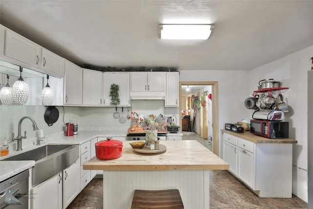 kitchen featuring range, white cabinets, sink, a kitchen island, and butcher block counters