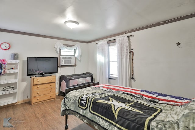 bedroom with hardwood / wood-style flooring and cooling unit