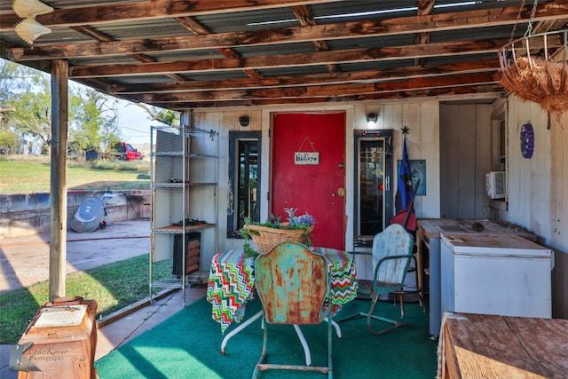 exterior space with concrete flooring and wooden walls