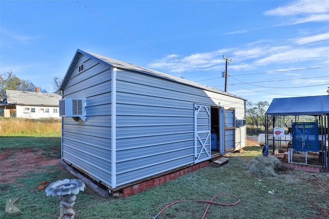 view of outbuilding with a lawn