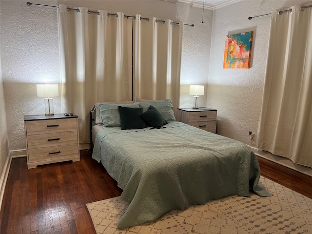 bedroom with crown molding and dark hardwood / wood-style flooring