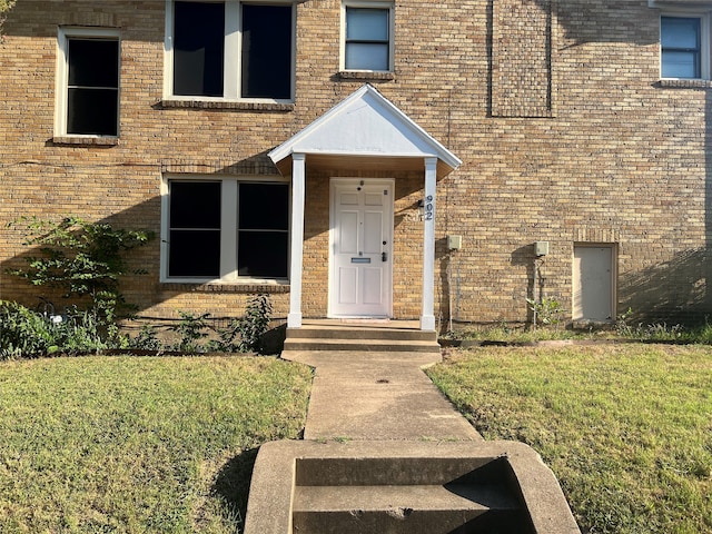 property entrance with a yard