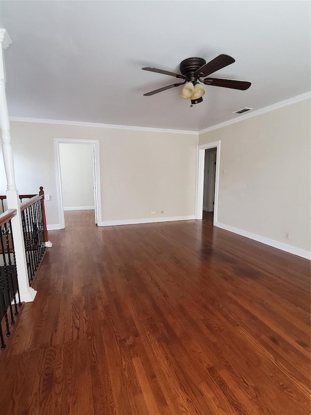 empty room featuring ornamental molding, ceiling fan, and dark wood-type flooring