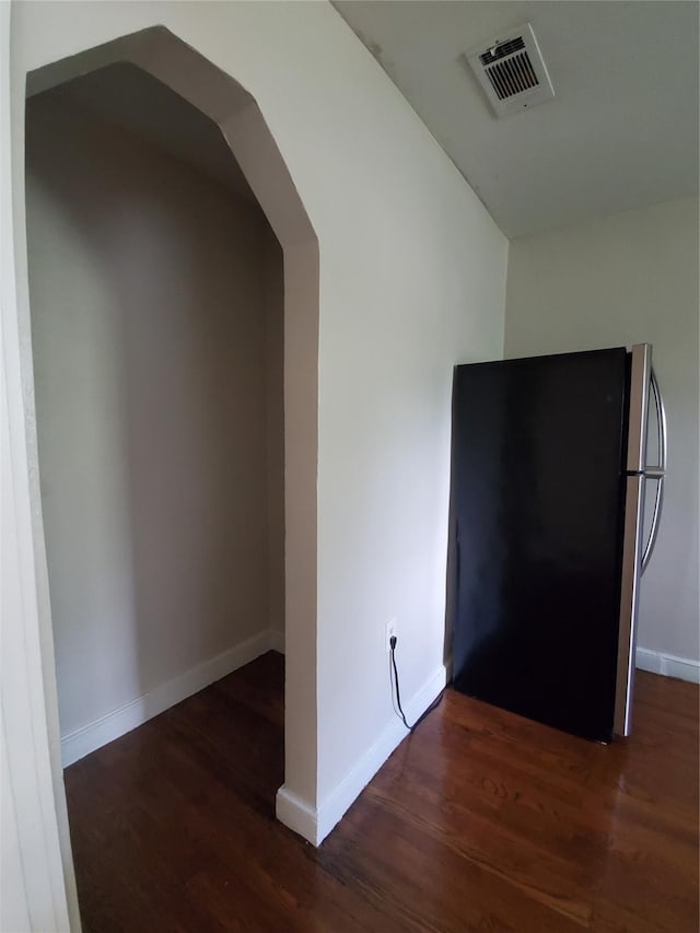 corridor featuring dark hardwood / wood-style flooring and lofted ceiling