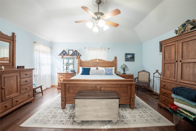 bedroom with vaulted ceiling, ceiling fan, and dark hardwood / wood-style floors