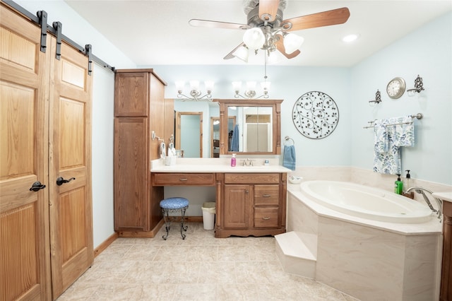 bathroom with tile patterned floors, a bathtub, ceiling fan, and vanity