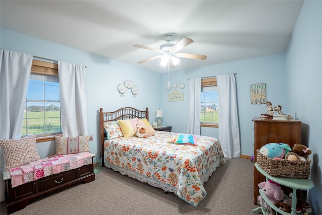 carpeted bedroom with multiple windows and ceiling fan