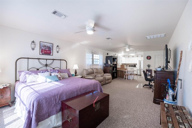 carpeted bedroom with ceiling fan and stainless steel fridge