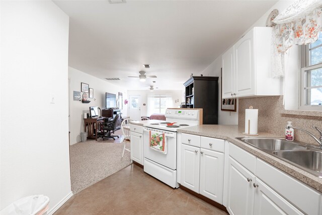 kitchen with white range with electric stovetop, a healthy amount of sunlight, white cabinetry, and sink