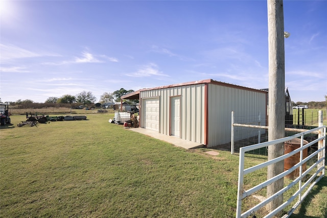 view of yard with a rural view and an outdoor structure