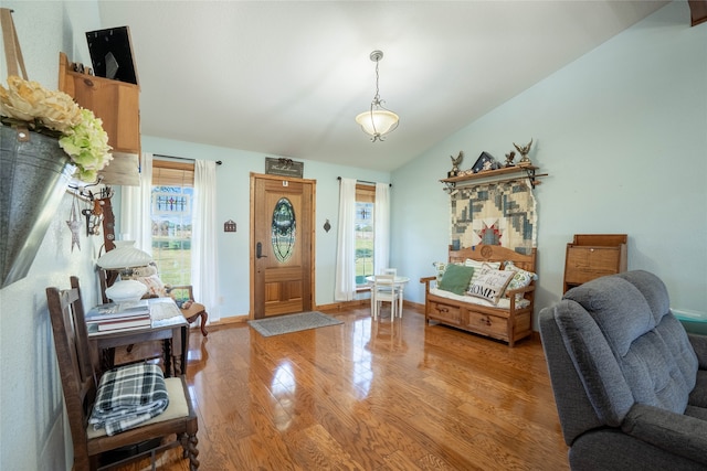 foyer featuring hardwood / wood-style floors and vaulted ceiling