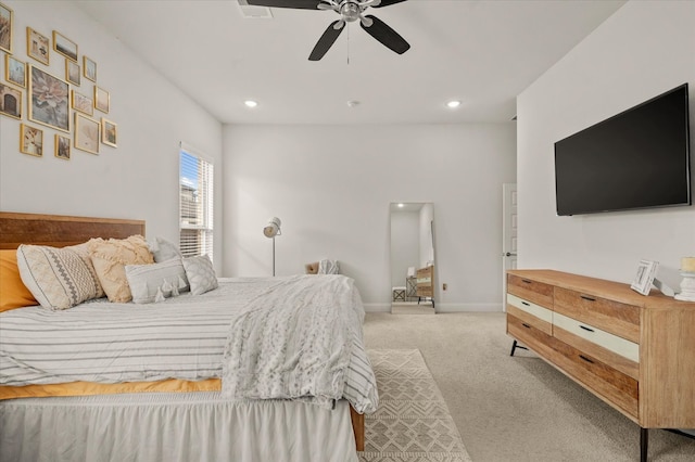 bedroom featuring light colored carpet and ceiling fan