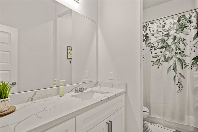 bathroom with vanity and toilet