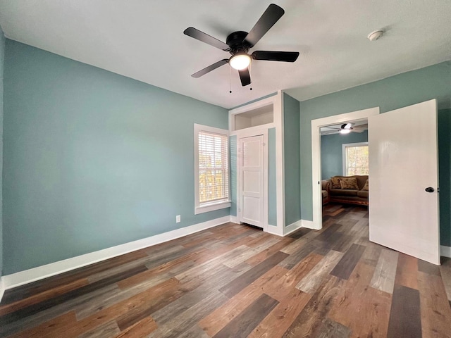 unfurnished bedroom with dark hardwood / wood-style flooring and ceiling fan