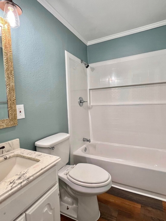 full bathroom with tub / shower combination, ornamental molding, vanity, hardwood / wood-style floors, and toilet