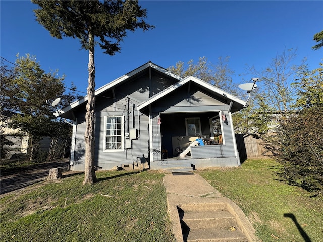 bungalow featuring a front lawn and a porch