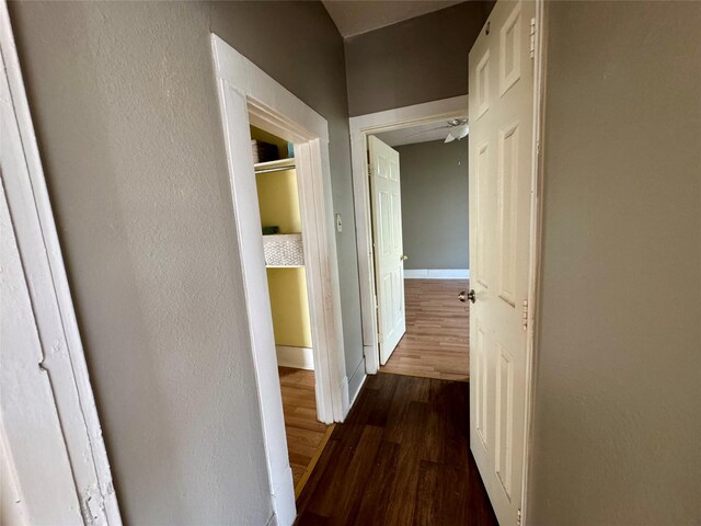 bedroom featuring an AC wall unit, vaulted ceiling, ceiling fan, a textured ceiling, and light tile patterned flooring