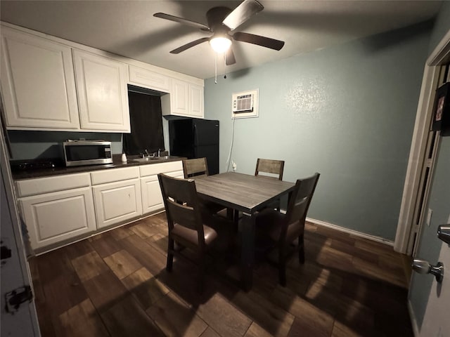 dining area featuring a wall mounted air conditioner, ceiling fan, dark hardwood / wood-style flooring, and sink