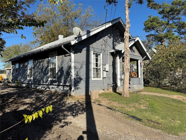 view of home's exterior with a yard