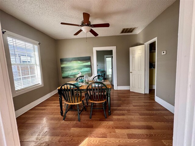 living room with ceiling fan and a textured ceiling